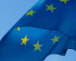 The blue EU flag with its yellow stars waving in the wind
